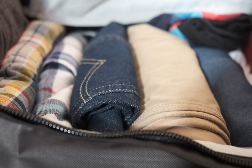 When packing for shorter trips, rolling articles of clothing is better than folding them. It saves space and keeps thing more visible. Photo by Brandon Mathis.