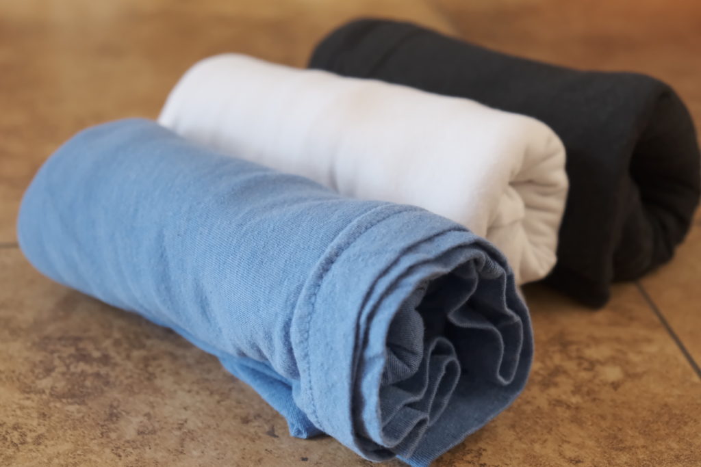 A few Tee-shirts are rolled up and ready for packing. Photo by Brandon Mathis.
